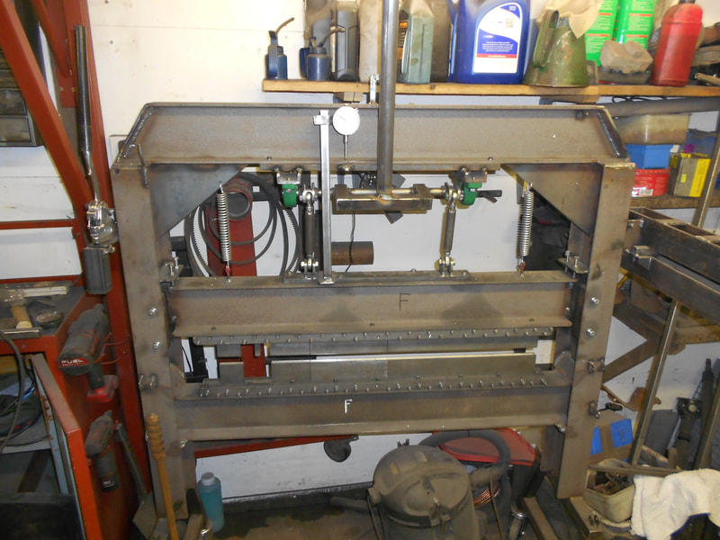 Front View of a home made brake press folding machine in a workshop.