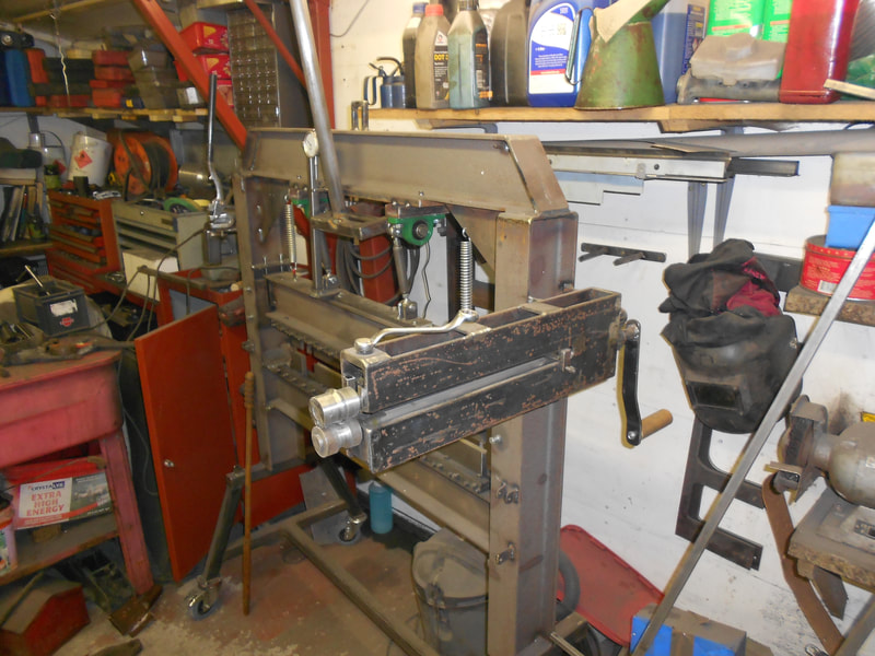 Side view of a home made brake press folding machine in a workshop.