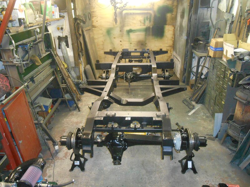 Land Rover Series 2a chassis on axle stands painted in black.
