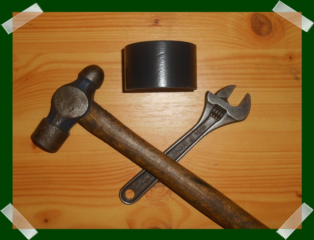 Land Rover Series Tool Kit consisting of a hammer, an adjustable spanner and some duct tape, meant to be sarcastic.