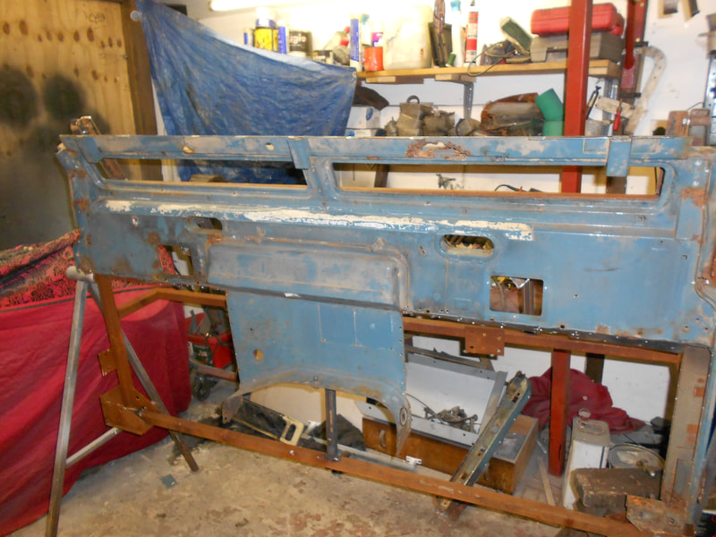 Old Land Rover Series 3 bulkhead in a jig ready to be repaired viewed from the back.