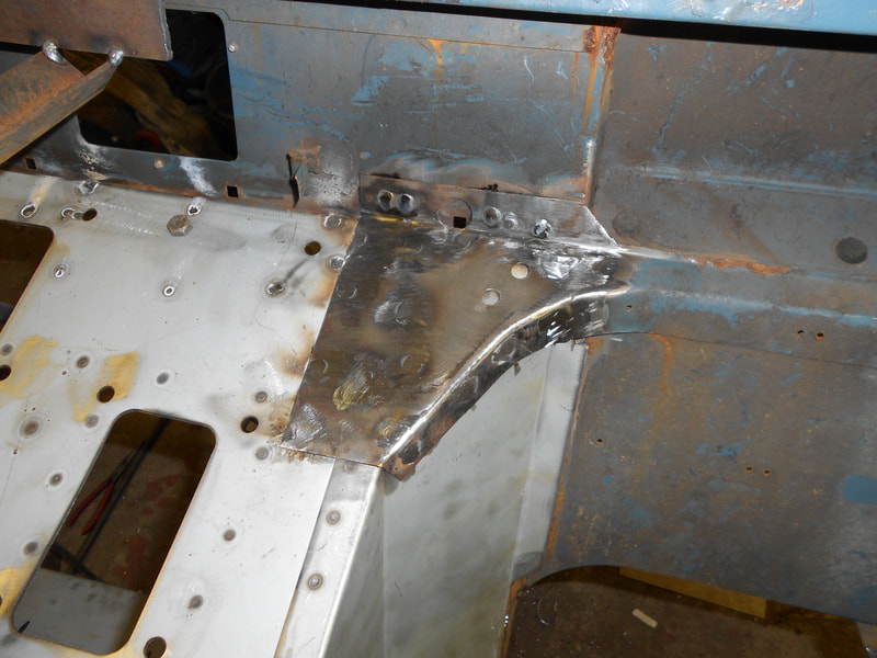 Close up of a repair section fitted to a Land Rover Series 3 bulkhead.