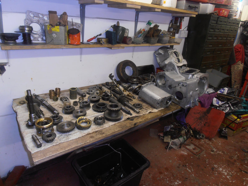 Land Rover Series 2a Gearbox completely stripped on table.