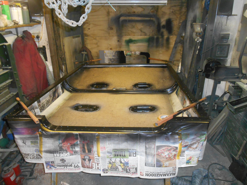 Inside of a Land Rover Series 2a Safari Roof with sound proofing in place and frame painted.
