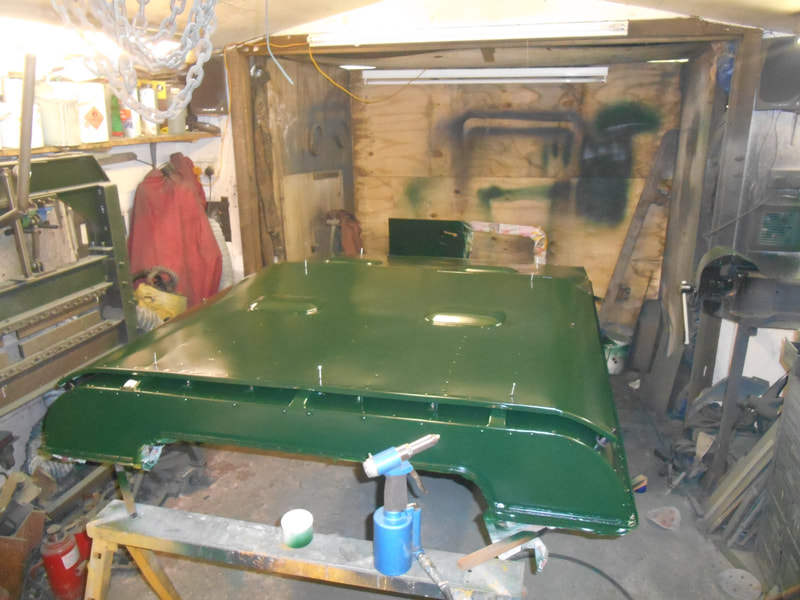 Rear top view of Land Rover Series 2a Safari roof with Safari skin fitted and painted in dark green.