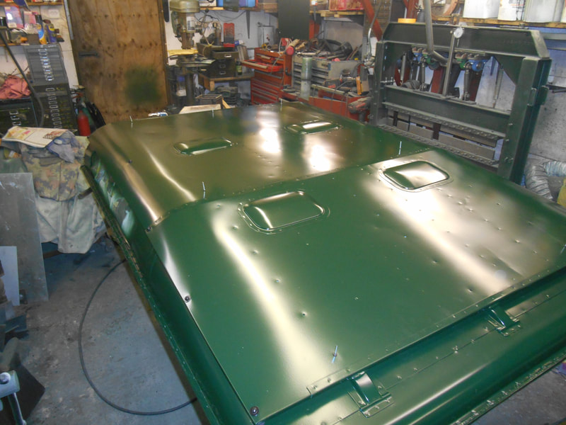 Front top view of Land Rover Series 2a Safari Roof with Safari skin fitted and painted in dark green.