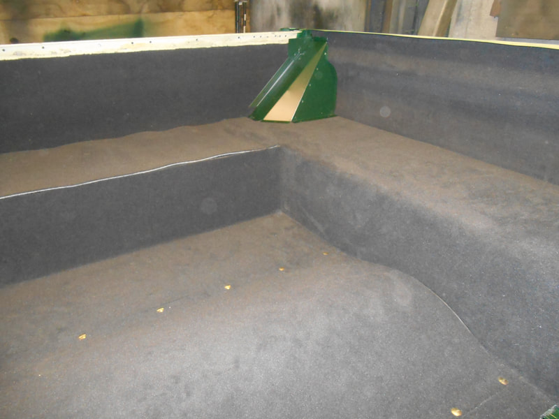 Wire cover in dark green fitted to carpeted Land Rover Series 2a Tub.