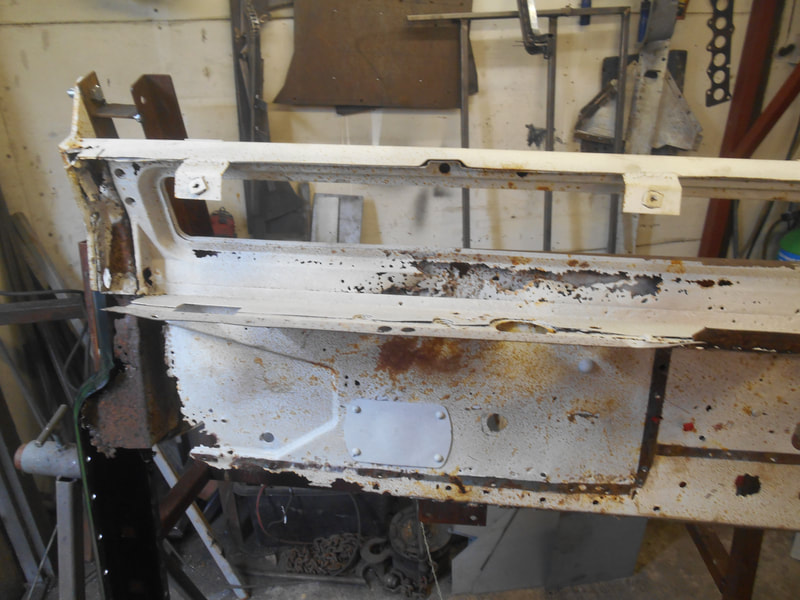 Remaining nearside part of a Land Rover Series 2a bulkhead in a jig.