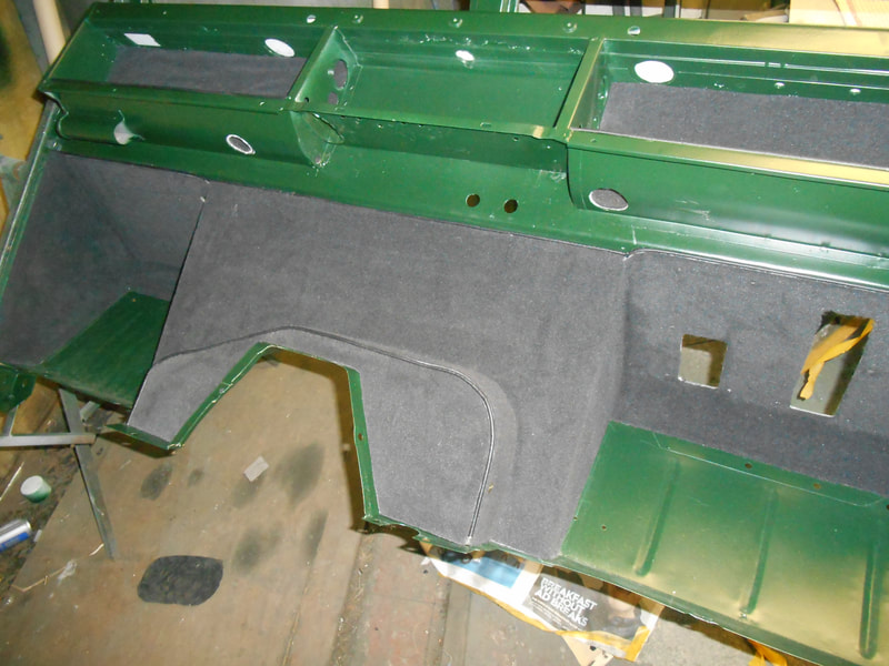 Land Rover Series 2a bulkhead painted in dark green with black carpet fitted to inside.