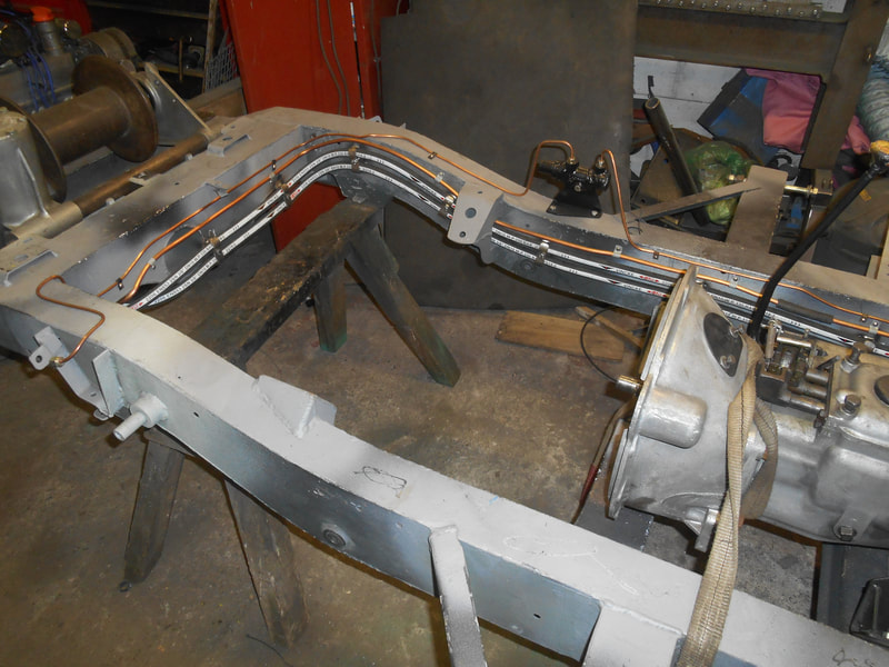 Hydraulic pipes neatly fitted with manufactured clamps to Land Rover Series 2a chassis.