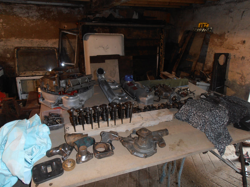 Parts of a stripped Land Rover Engine on a table after having been cleaned.